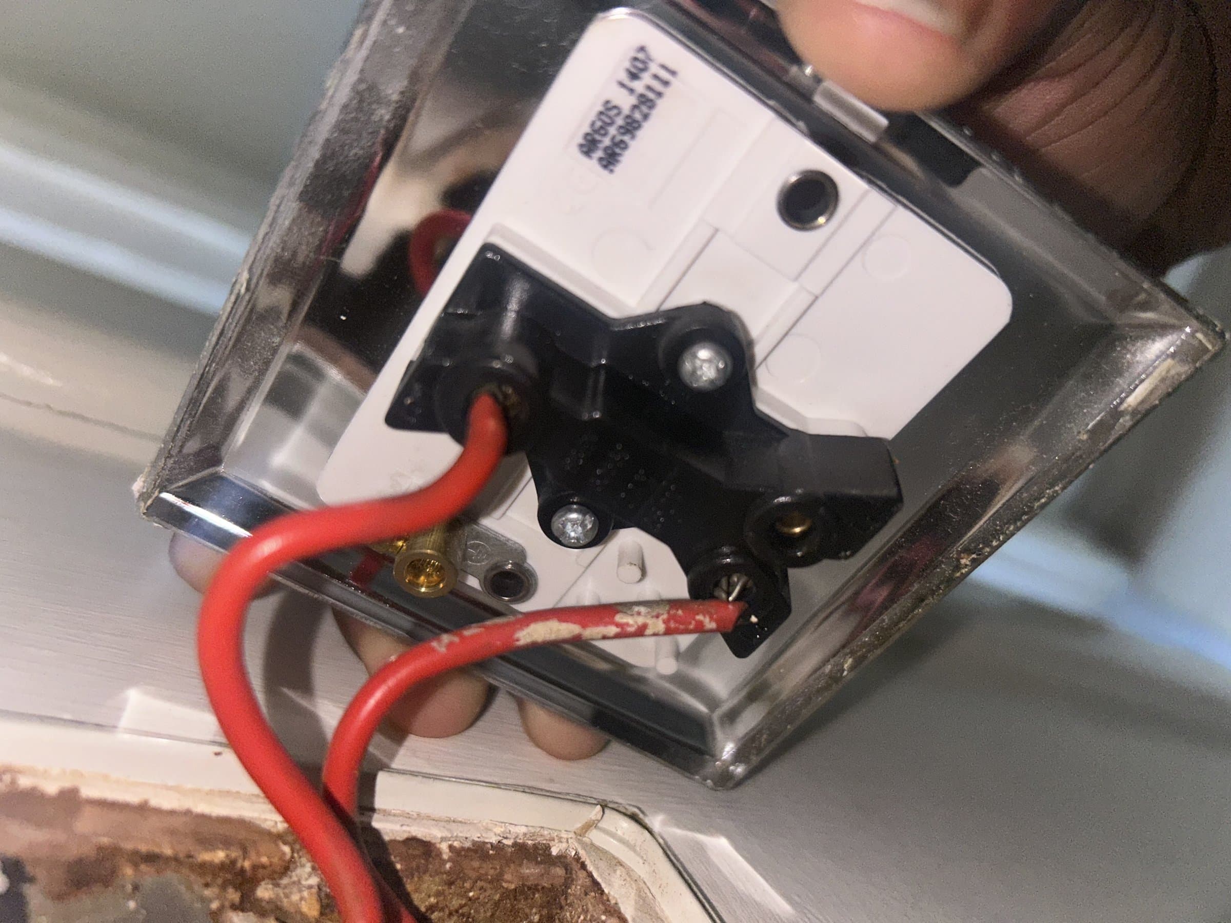 Close-up of electrical wiring connected to a socket terminal