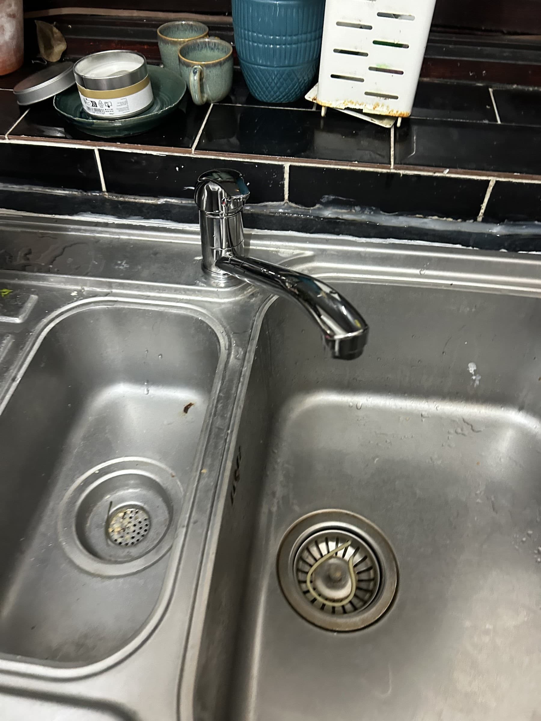 New chrome pull-out kitchen mixer tap fitted to a stainless steel double sink